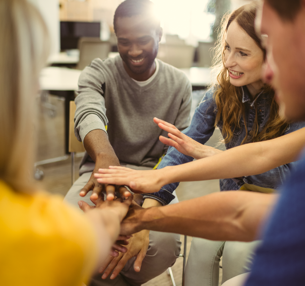 business-executives-with-hand-stacked 1 business-executives-with-hand-stacked 1
