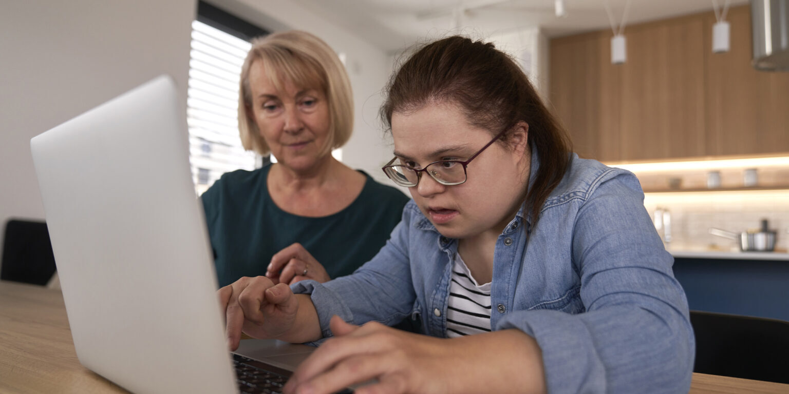 down-syndrome-woman-using-computer-with-help-of-he-2024-12-04-19-09-18-utc down-syndrome-woman-using-computer-with-help-of-he-2024-12-04-19-09-18-utc
